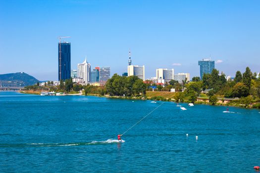 VIENNA, AUSTRIA - AUGUST 6: Waterskiing in Vienna modern city skyline on background, Austria