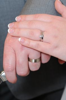 Bride and grooms hands holding knife