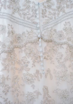 Close-up of brides dress detail on wedding day