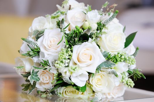 Wedding day closeup of brides bunch of white roses