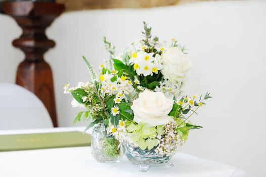 Closeup  of flower arrangement decorating ceremony room at wedding