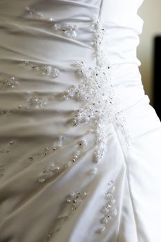 Brides wedding dress closeup of decoration detail