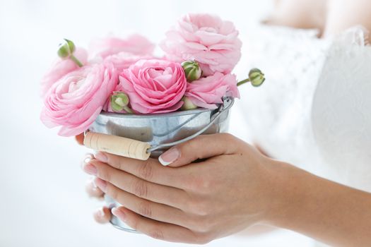 Wedding. Attractive bride holding pot with beautiful roses