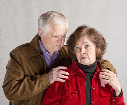 Concerned mature husband comforting depressed senior wife