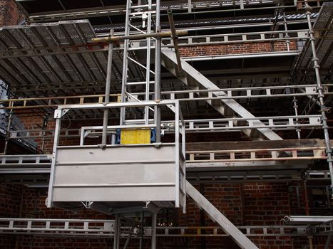 Modern sophisticated scaffolds on a house building under extensive renovations