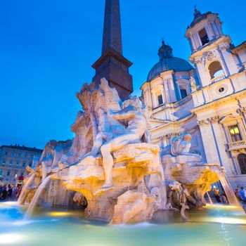 Fountain of the four Rivers and SantAgnese in Agone on Navona square in Rome, Italy, Europe shot at dusk.