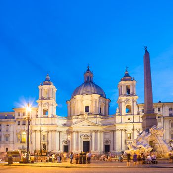 Fountain of the four Rivers and SantAgnese in Agone on Navona square in Rome, Italy, Europe shot at dusk.