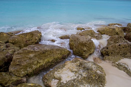 giant stone being pounded by waves