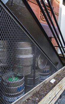 multiple barrel of kegs hidden under a stair case