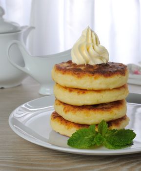 Stack cake with mint cheesecakes on the table