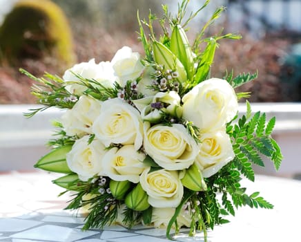 Closeup of brides bunch of white roses on wedding day