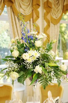 Flower arrangement decorates table at wedding reception