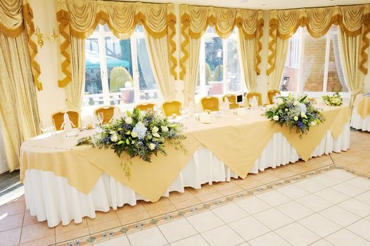 Decoration of flowers on head table at wedding reception
