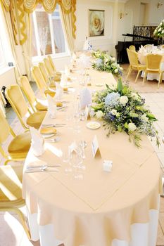 Top table at wedding reception decorated with flowers