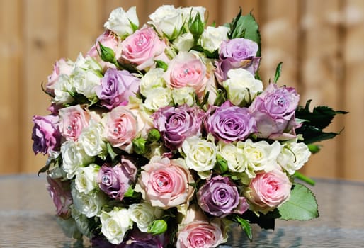 Bouquet of bride on wedding day with pink and purple roses