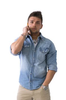 Handsome young man talking on cell phone (mobile), isolated on white. Looking at camera