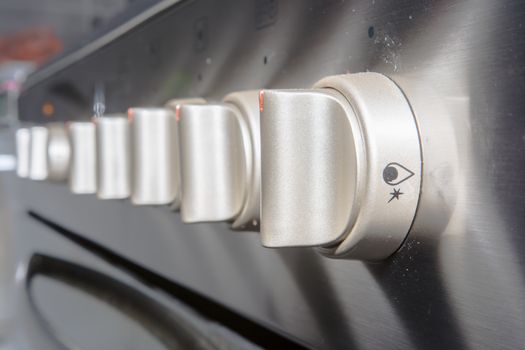 Close up of controls from a modern stainless steel oven