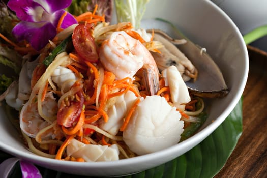 Traditional dish of freshly prepared Thai food.  Thai seafood and som tum green papaya salad.