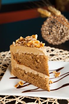 Slice of almond toffee cake with coffee flavored icing.