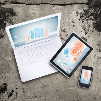 Laptop, tablet pc and smart phone on old concrete surface. Computer technology concept