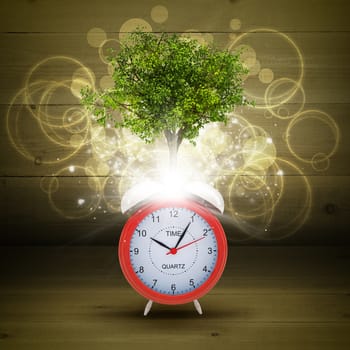 Alarm clock with magical green tree and rays of light on dark background
