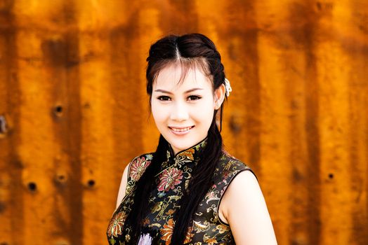 Chinese girl in traditional Chinese cheongsam blessing