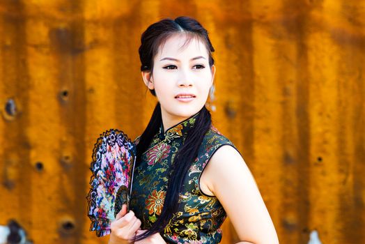 Chinese girl in traditional Chinese cheongsam blessing