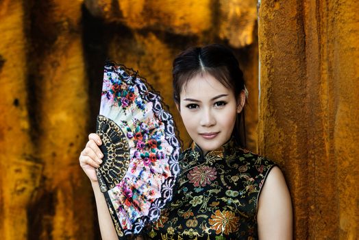 Chinese girl in traditional Chinese cheongsam blessing