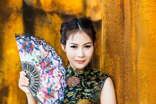 Chinese girl in traditional Chinese cheongsam blessing