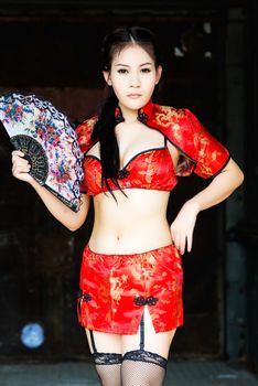 Chinese girl in traditional Chinese cheongsam blessing