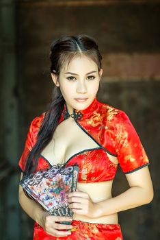 Chinese girl in traditional Chinese cheongsam blessing