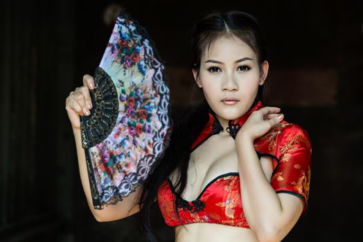 Chinese girl in traditional Chinese cheongsam blessing