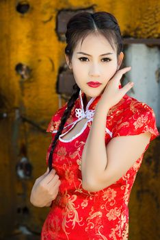 Chinese girl in traditional Chinese cheongsam blessing