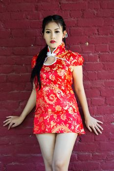 Chinese girl in traditional Chinese cheongsam blessing