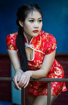 Chinese girl in traditional Chinese cheongsam blessing