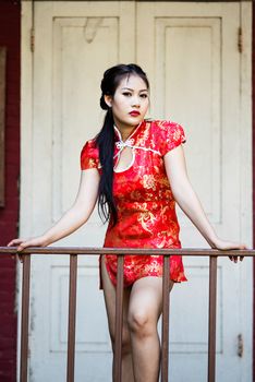 Chinese girl in traditional Chinese cheongsam blessing