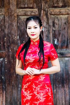 Chinese girl in traditional Chinese cheongsam blessing