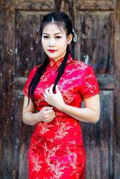 Chinese girl in traditional Chinese cheongsam blessing