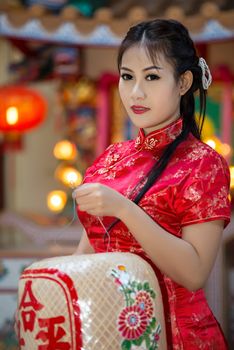 Chinese girl in traditional Chinese cheongsam blessing