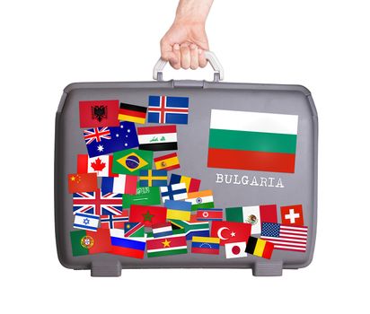Used plastic suitcase with lots of small stickers, large sticker of Bulgaria
