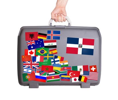Used plastic suitcase with lots of small stickers, large sticker of Dominican Republic