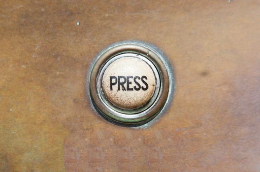 Grunge image of a button from the control area for an old elevator lift or doorbell