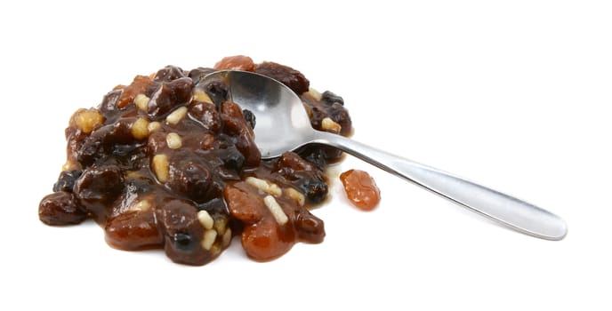 Heap of mincemeat mixture with a metal teaspoon - with copy space, isolated on a white background