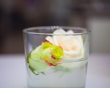 Close up of two reses inside the glass