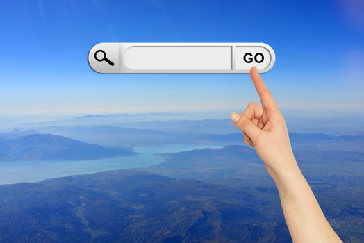 Human hand indicates the search bar in browser. Mountain, river and sky on background