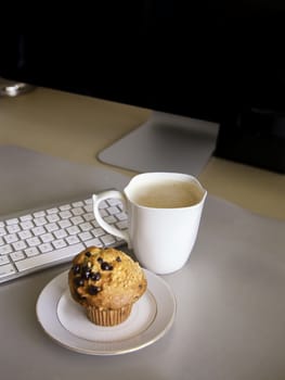 Lunch Break at the desk, coffee and muffin