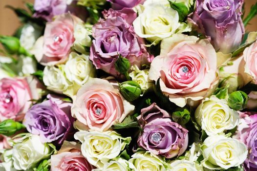 Brides bunch of flowers on wedding day is pink and purple roses closeup