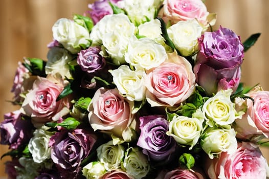 Brides bunch of colorful flowers are pink and purple roses