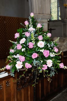 Flower arrangement decorates church on wedding day