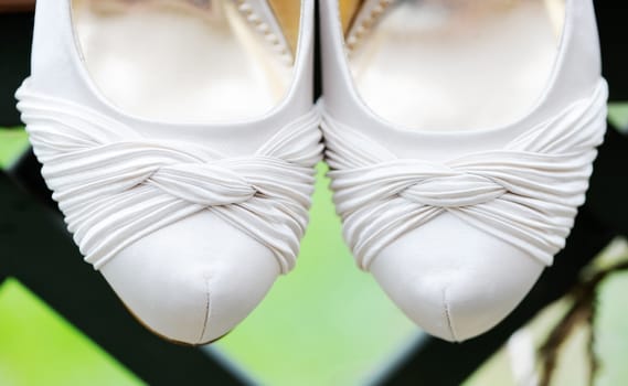 Brides white shoes closeup on wedding day